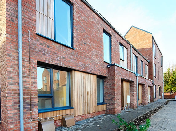 Rainmen Liverpool installation - galvanised steel rainwater systems and hoppers with aluminium pike cappings on 2-3 storey homes featuring timber veneer cladding