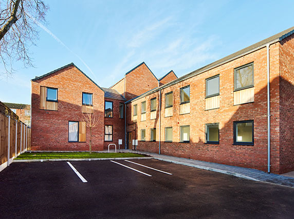 Rainmen Liverpool project - rear elevations from quad area showing complete Zambelli galvanised steel rainwater drainage systems with downpipes and aluminium pike cappings on social housing