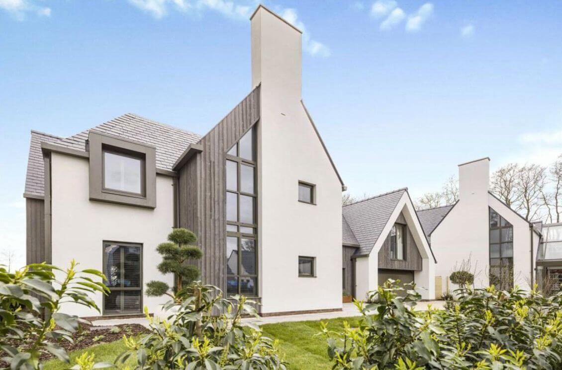 Aluminium box gutters, square rainwater pipes and aluminium window surrounds on a contemporary high-specification new-build in Wilmslow, Cheshire