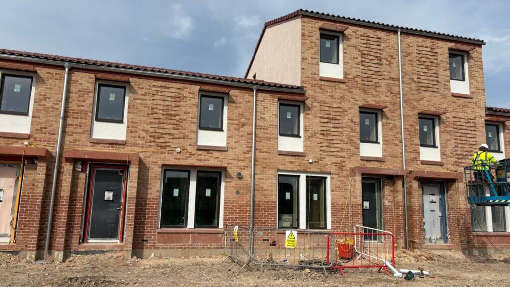 Lindab galvanised steel downpipes installed on new-build social housing blocks at Duncombe Barracks and Burnholme, York — Housing Design Award 2025 winner